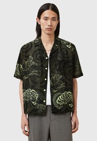 Short-sleeve shirt in dark green with contrasting yellow dragon and swirl patterns, featuring a relaxed fit and button-down front.