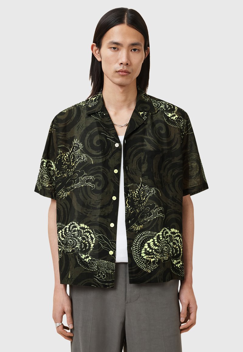Short-sleeve shirt in dark green with contrasting yellow dragon and swirl patterns, featuring a relaxed fit and button-down front.