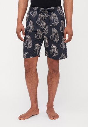 Marine svømmeshorts med hvit tigertrykk, laget av lett stoff med elastisk midje og snøring.