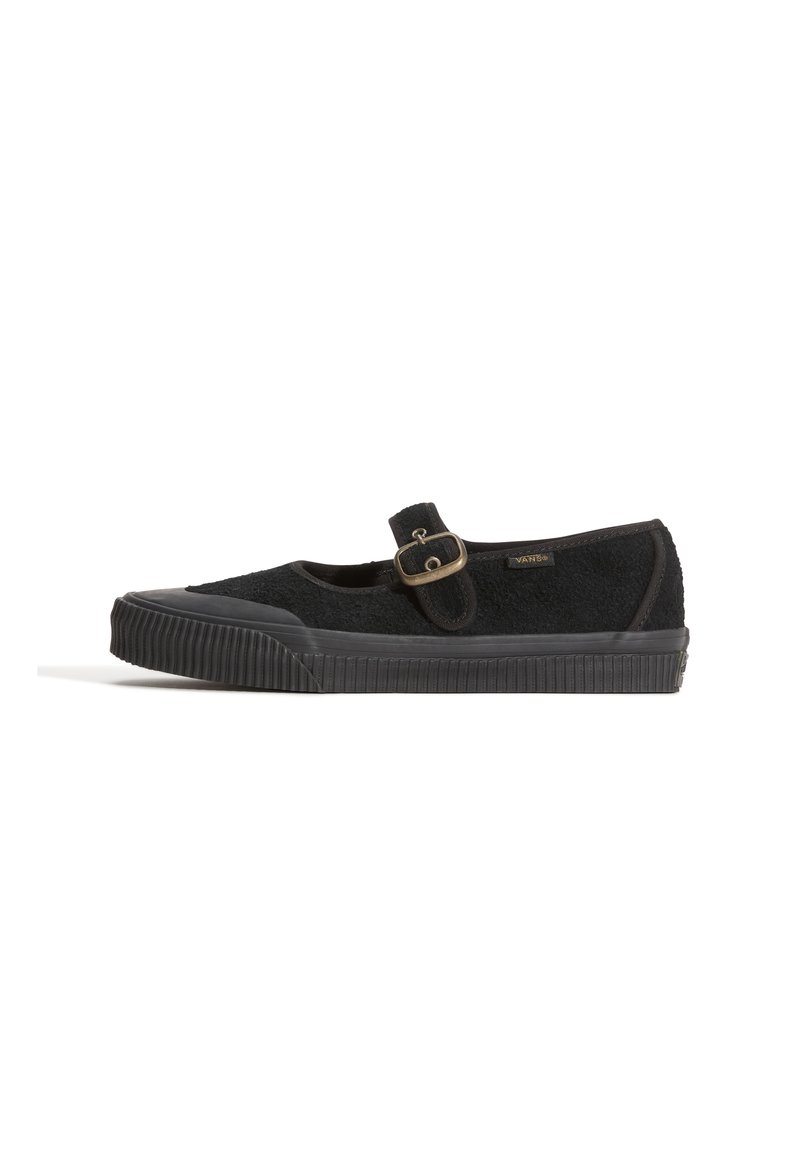 Black slip-on shoe with a textured fabric upper, round toe, and side buckle detail. Thick rubber sole with ridged pattern for traction.