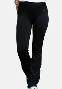 Svarta ribbstickade leggings av elastiskt material med bred midjeresår, åtsittande design och utan synliga detaljer eller mönster.