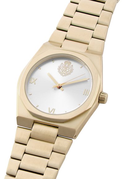 Gold-tone octagonal watch with a silver dial, Roman numerals, and a metal link bracelet. Features a crown on the side for adjustments.