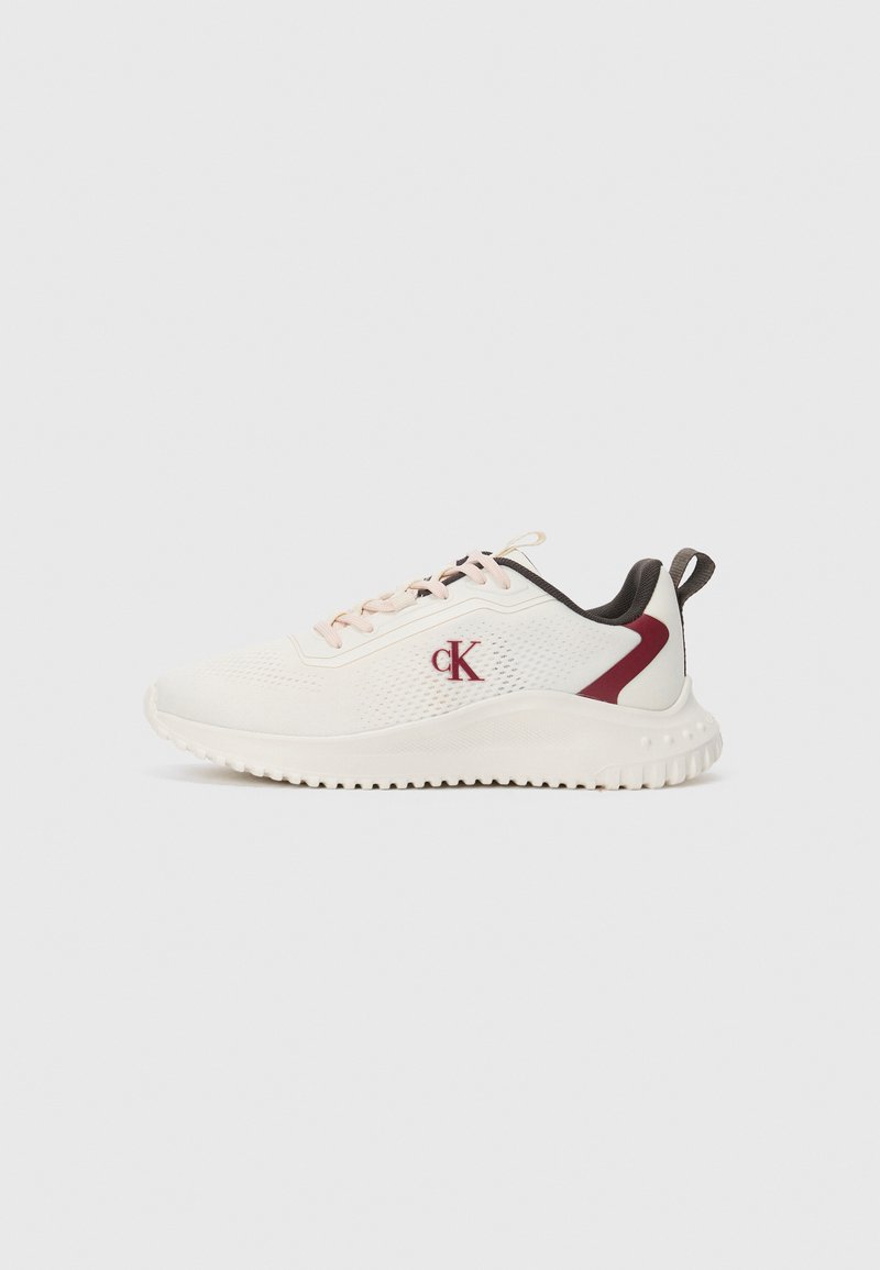 White athletic sneaker with pink laces, burgundy heel accents, and a red CK logo on the side, set against a plain background.