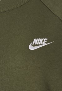 Olivengroen sweatshirt met een geribde hals, met een wit geborduurd Nike-logo op de linkerborst. Zachte, gestructureerde stof.