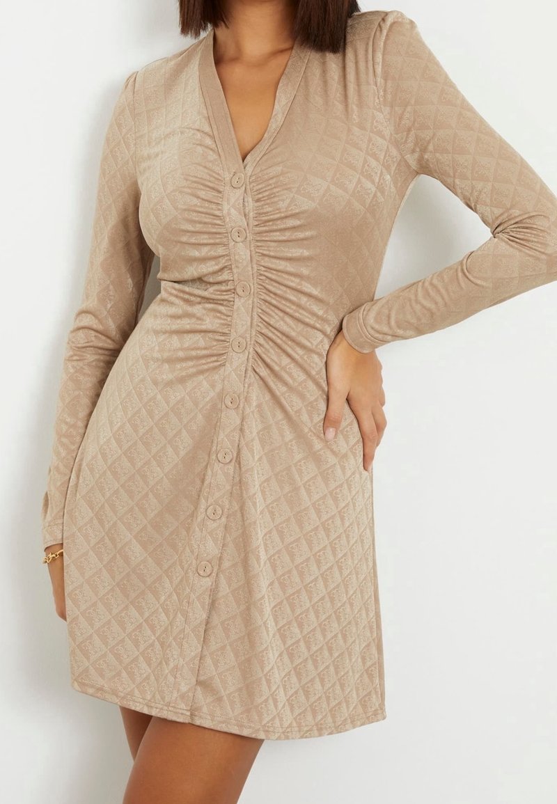 Tan, quilted long-sleeve dress with a V-neck, featuring a button-down front and subtle texture. Smooth fabric with gathered detailing.