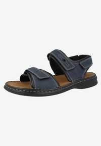 Navy blue sandal with two adjustable straps, a soft padded lining, and a flexible black sole. Features contrasting white stitching on the upper.