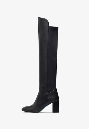 Black knee-high boots featuring a smooth leather exterior, block heel, and sleek design with contrasting textile panel on the back.