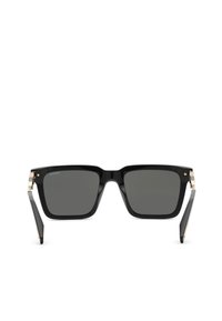 Lunettes de soleil noires à monture carrée avec verres foncés et charnières dorées, branches pliées légèrement inclinées vers l’extérieur, vue de face sur fond blanc.