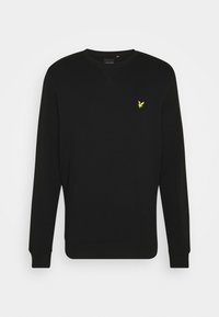 Svart sweatshirt med rund hals, långa ärmar, ribbade muddar och nederkant. Utmärkande gult logotypdetalj på bröstet. Mjuk textur.