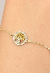 Bracciale dorato con un design ad albero circolare, impreziosito da cristalli trasparenti, su una delicata catena.