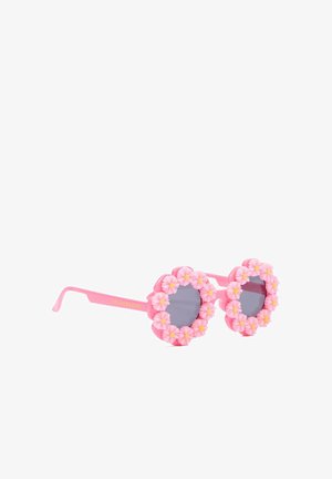Lunettes de soleil rondes roses avec des verres gris, décorées d'accents de fleurs roses et jaunes en relief autour des montures.