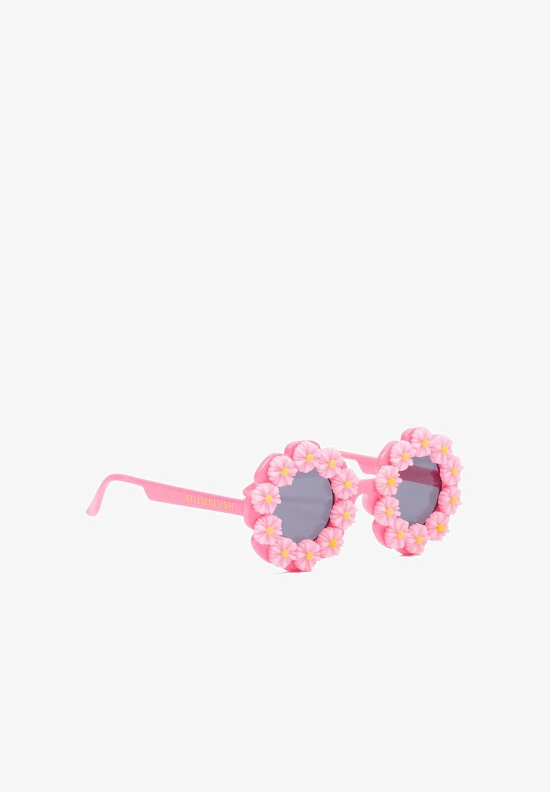 Occhiali da sole rotondi rosa con lenti grigie, decorati con accenti floreali rosa e gialli in rilievo intorno alle montature.