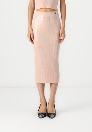 Pink ribbed midi skirt with a fitted waistband and sequin accents, paired with black peep-toe heels. Texture appears soft and shiny.