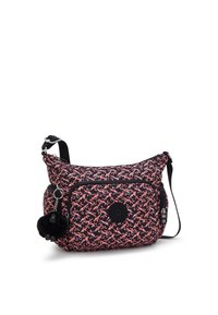 Sort og lyserød mønstrede crossbody taske i stof med et rundt logo, lynlåslommer og en sort pom-pom charm hængende på.