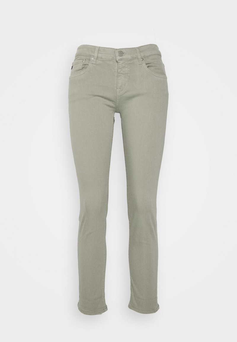Jeans ajustados de color verde claro con una cinturilla de altura media, cinco bolsillos y detalles de costura sutiles. Fabricados con una mezcla de algodón elástico.