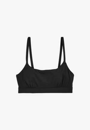 Bralette nera con spalline sottili, fascia elastica, dettaglio arricciato al centro, realizzata in tessuto morbido con una finitura liscia e senza hardware visibile.