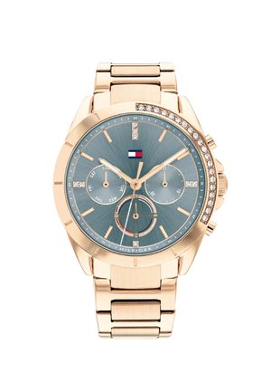 Orologio color oro rosa con quadrante blu texturizzato, dettagli in cristallo e sottocronografi multifunzionali su un bracciale in metallo lucido.