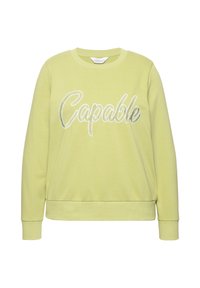 Felpa verde chiaro con maniche lunghe, polsini e orlo a coste. Presenta il testo ricamato bianco "Capable" sulla parte anteriore. Morbido al tatto.