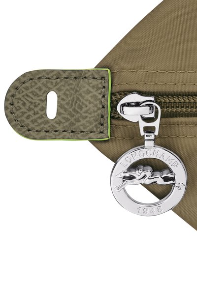 Olive green nylon zipper component with a textured fabric tab, featuring a silver round charm with a galloping horse and "LONGCHAMP 1948" inscription.