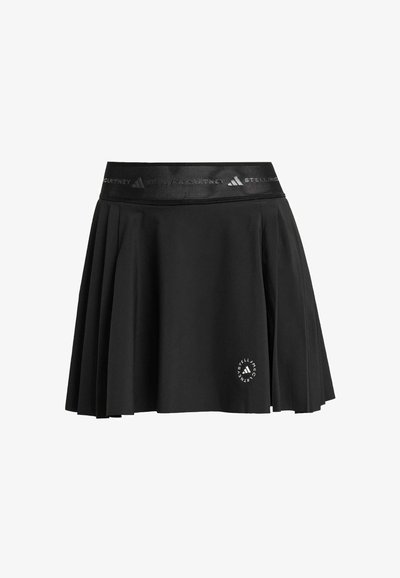 Falda deportiva negra con diseño plisado, cintura elástica con marca y un detalle de logo circular en la parte inferior izquierda.