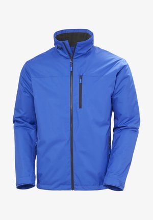 Blauere wasserdichte Jacke mit hohem Kragen, vorderem Reißverschluss und zwei seitlichen Taschen. Enthält einen kontrastierenden Reißverschluss und ein Logodetail auf der Brust.