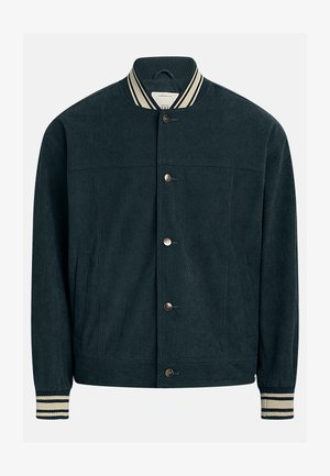 Tumši zaļa kordurojveida jaka ar ribotu apkakli un aprocēm, divām priekšējām kabatām un pogu aizdari pa vidu.