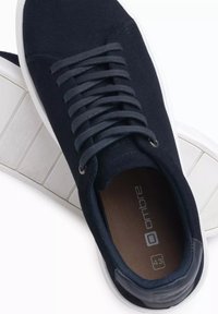 Marineblaue Wildledersneaker mit einer weißen Gummisohle, featuring tonale Schnürsenkel, Metallösen, einer strukturierten Innensohle und minimalistischer Markenkennzeichnung auf der Zunge.