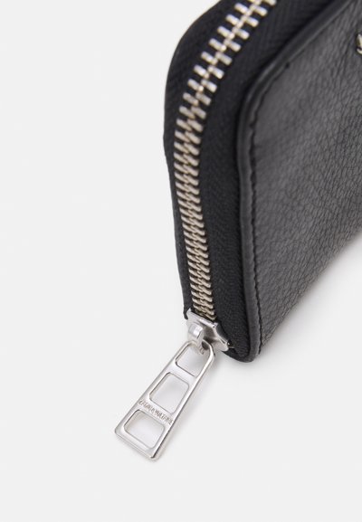 Black wallet with textured leather finish, silver zipper hardware, and a distinctive metal zipper pull featuring cut-out design.