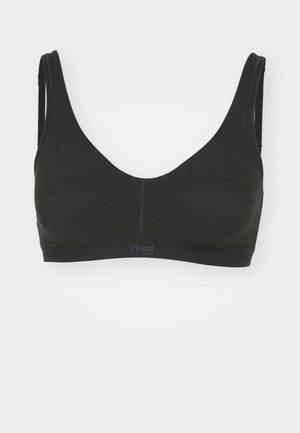 Bralette wireless nera con una texture liscia, spalline larghe e un design senza cuciture. Il logo del marchio è visibile sull'elastico.