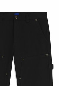 Black utility pants with front pockets, rivet details, belt loops, button closure, and a tape loop on the side leg.