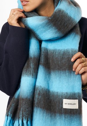 Blue and gray striped scarf made of soft, textured fabric with fringed ends; tag labeled "MY JEWELLERY" visible on a gray section.