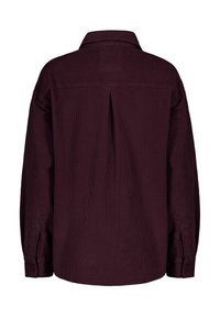 Burgundy corduroy shirt with a back yoke, pleat detail, and buttoned cuffs. Features a collar and a textured surface.