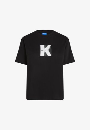 Crna pamučna majica s okruglim izrezom, s bijelim grafičkim dizajnom stiliziranog slova "K" i okomitih linija na prednjoj strani.