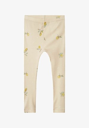 Beżowe legginsy w prążki z wzorem cytryn i liści, z elastycznym pasem i dopasowanym krojem.
