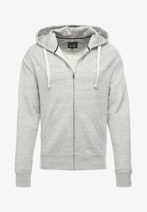 Halluki värvi tõmblukuga kapuutsiga sviiter, mis on valmistatud pehmest tekstureeritud kangast. Omab reguleeritavat kapuutsi, eesmist taskut ja soonikkoes mansette ning allserva.