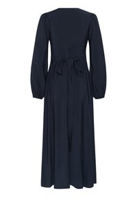 Robe midi bleu marine à manches longues avec ceinture nouée à la taille, manches bouffantes et jupe légèrement évasée, vue de dos.