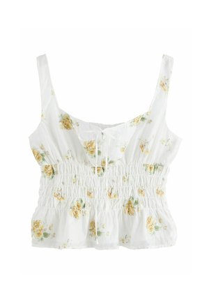 Bílý bezrukávový crop top se žlutým květinovým potiskem, nařaseným elastickým pasem a malou přední mašlí.