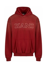 Crvena hoodie sa prednjim kengur čepom, sa izvezenom riječi "KANI" u bijeloj boji. Mekani materijal, rebrasti manžeti i pojas.