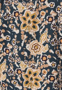 Floral fabric featuring large, abstract flowers in beige, mustard, and deep burgundy on a dark navy background with a textured, soft appearance.