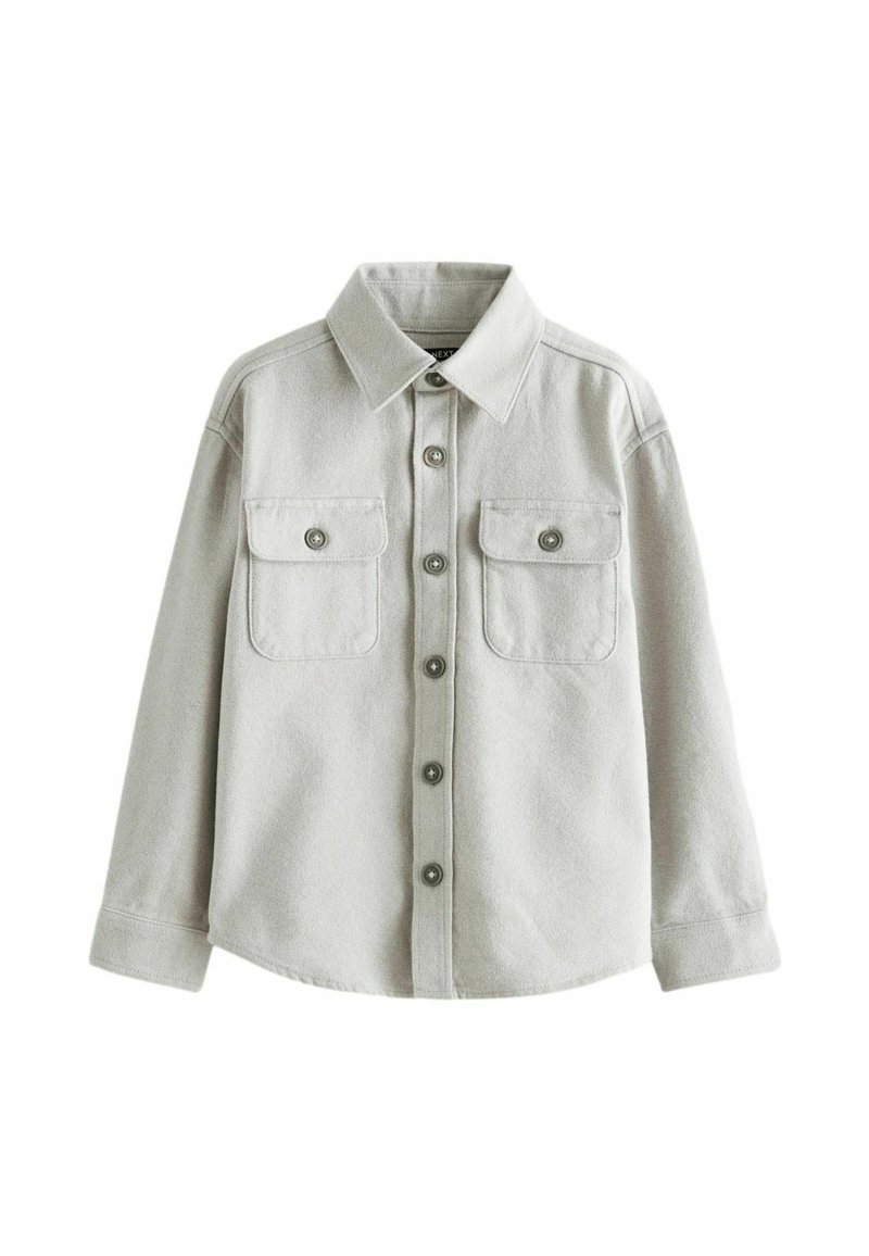 Light gray button-up shirt made of textured fabric, featuring a collar, two chest pockets, and metal button accents.