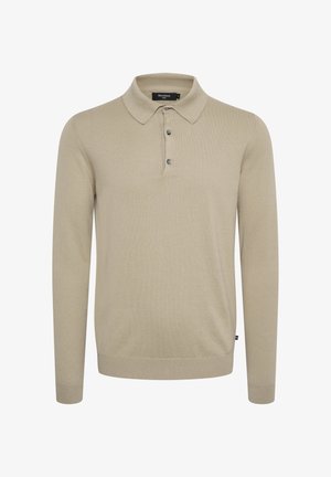 Pika varrukatega polo särk heledast beežist kudumstoffist, klassikalise krae, kolme nupuga kinnituse ja soonikkoes randmetega.