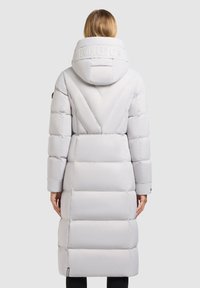 Light gray puffer coat with a hood, featuring a pronounced quilted pattern, adjustable collar, and logo detailing on the back.