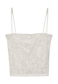 Top corto de encaje blanco con tirantes finos, patrón floral y un sutil detalle de lazo en el centro, con una tela transparente y texturizada.