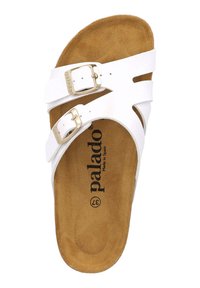 Sandalia de slide blanca con dos hebillas ajustables. Parte superior hecha de material suave, plantilla marrón contorneada y marca "palado" visible.