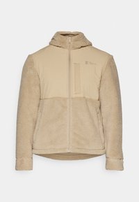 Beige Fleece-Jacke mit einer strukturierten, flauschigen Außenseite. Verfügt über einen Reißverschluss, eine Kapuze und eine Brusttasche. Glattes Material im oberen Bereich.