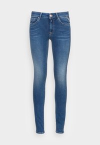Vaqueros ajustados de tela de denim en color azul, con cremallera y botón, cinco bolsillos y un ligero desgastado en los muslos.