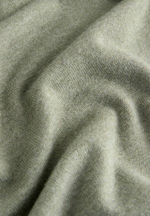 Light green knitted fabric with a soft texture, featuring visible stitching and a smooth, consistent surface. Ideal for apparel or upholstery.