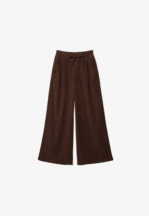 Weit geschnittene braune Cordhosen mit elastischem Bund und Kordelzug, seitlichen Taschen vor weißem Hintergrund.