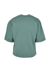 T-shirt vert sauge à manches courtes et col rond, vu de dos, avec une coupe ample et un design uni.