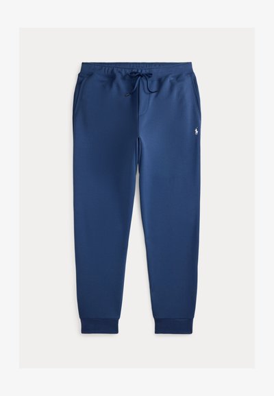 Μπλέ σκούρες φόρμες jogger κατασκευασμένες από μαλακό ύφασμα, με ελαστική μέση και κορδόνι, πλεκτές μανσέτες και μικρό κεντητό λογότυπο.
